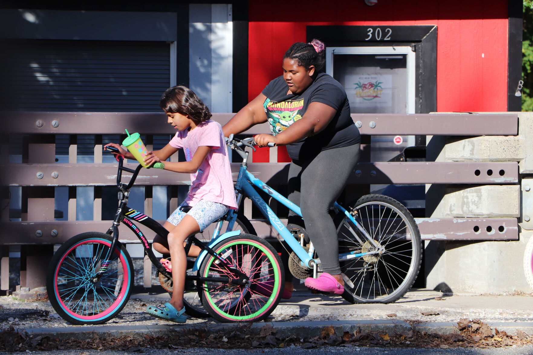 A group of kids ride their bikes
